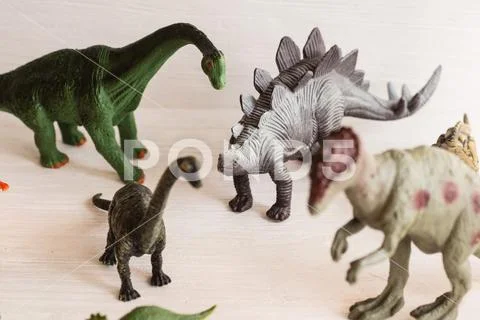 Plastic dinosaur figures of extinct ancient creatures and favorite toys of k Stock Photos