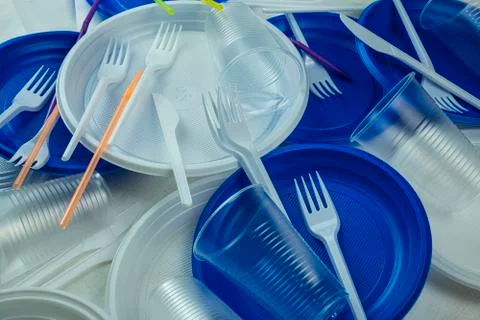 Plastic dishes of different colors on table Stock Photos