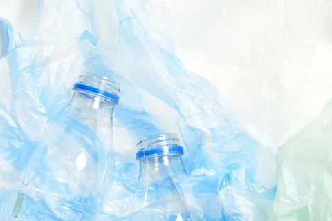 Plastic disposable bottles over single use plastic bags. Recycle, sustainabil Foto stock