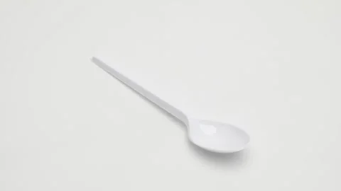 Plastic disposable spoon rotates on a white background. 動画素材 270061077
