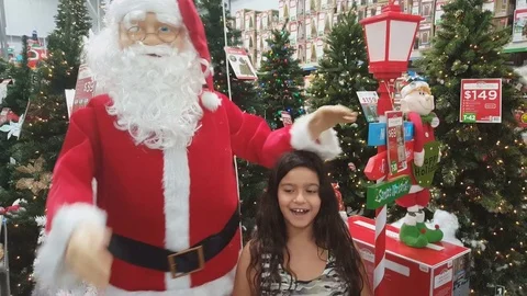 Plastic doll Santa Claus Girl Dancing In Front Of Christmas Tree Stock Footage 74062353