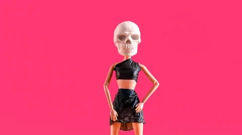 Plastic doll with skull for head dressed in  black leather top and skirt on.. Stock Photos