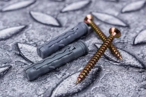 Plastic dowels with self-tapping screws on a grey background 스톡 사진