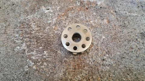 Plastic drainage pipe fitting on concrete floor. White PVC plumbing connector Stock Photos