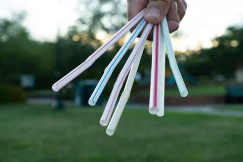 Plastic Drinking Straws held toward camera fanned out Stock-Fotos