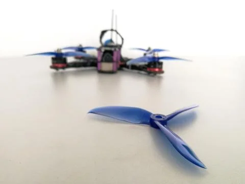 Plastic drone propeller in front of racing drone Stock Photos