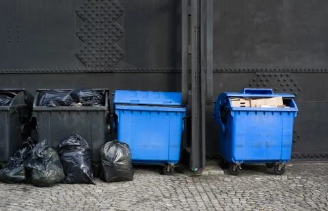Plastic dumpsters in different colors because of recycling. Stock Photos