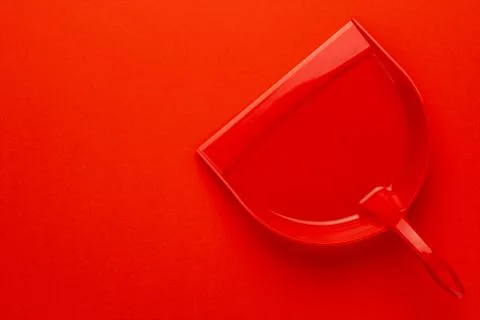 Plastic dustpan on red background Stock Photos