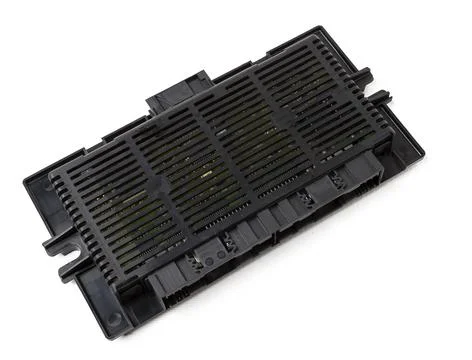 Plastic electronic control unit with black and blue connectors on a white iso Stock Photos