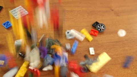 Plastic elements of the children's constructor fly to the sides, falling on the  Stock Footage 233672452