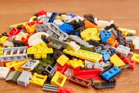 Plastic elements of the children's constructor fly to the sides, falling on.. Stock Photos