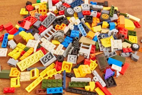 Plastic elements of the children's constructor fly to the sides, falling on.. Stock Photos