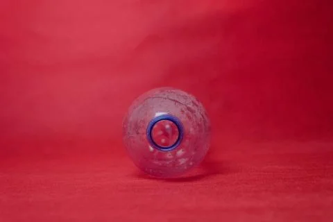 Plastic empty bottle on a red background with space for text. Concept of envi Stock Photos