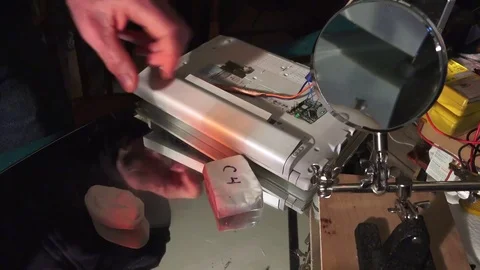 Plastic explosive loaded into laptop computer, hands rolling out to thin. Stock-Footage 74279294