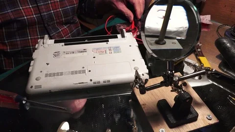 Plastic explosive loaded into laptop computer, handling explosive Stock-Footage 74362701