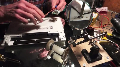 Plastic explosive loaded into laptop computer, removing screws Stock-Footage 74381975