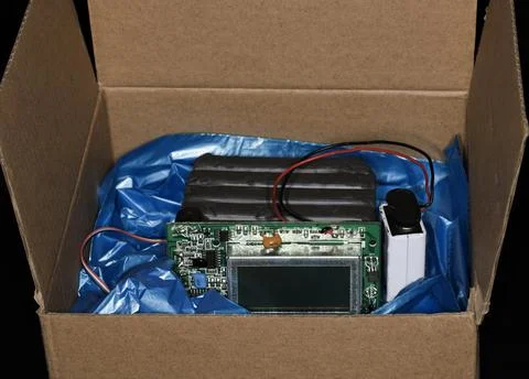 Plastic explosive with timer and battery lies in a box dummy studio photography 스톡 사진