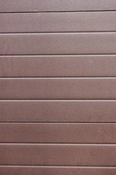 The plastic exterior siding on automatic garage doors closes up Stock Photos