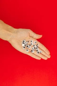 Plastic eyes for decor on a red background Stock Photos