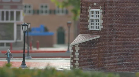 A plastic figurine and a light post near a building at the Mini-Europe, Brussels Video stock 60251333