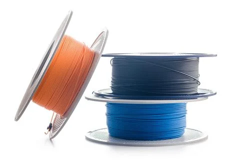Plastic filament on a spool for 3D printer isolated on white background. Stock Photos