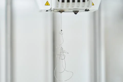 Plastic filament stuck in the 3D printer nozzle. Fotos de archivo