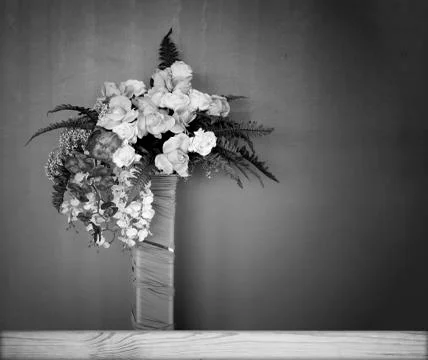 Plastic flowers on a black background. Stock Photos