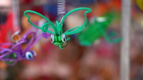 Plastic flying green bug toy at street market. Stock Footage 150499764