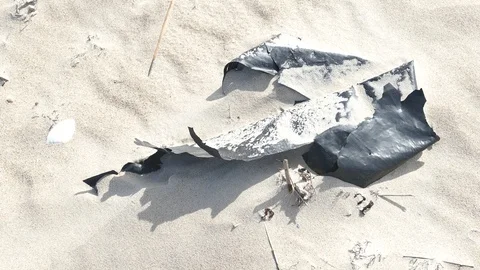 Plastic foil pollution in beach sand Stock-Footage 121669162