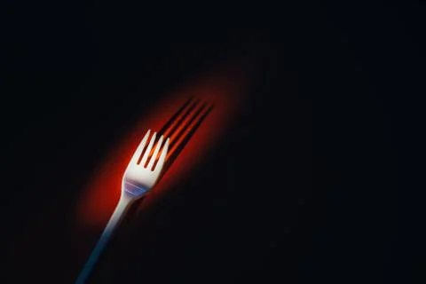 A plastic fork on a red background. Stock Photos