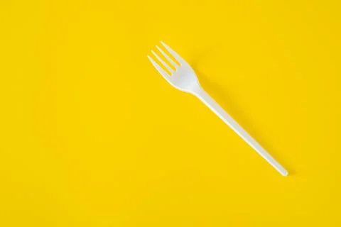 Plastic fork on yellow background Stock Photos