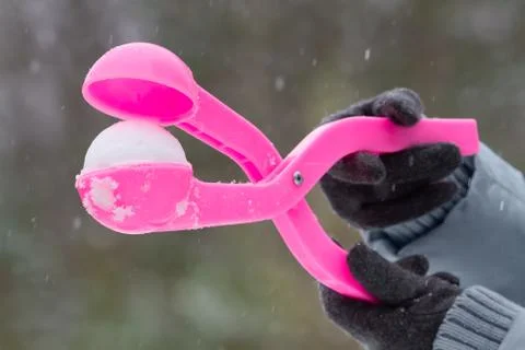 Plastic form for making a snowball in hands Stock Photos
