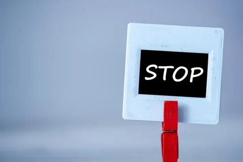 Plastic frame with clothes pin on table. White frame with black background an Stock Photos