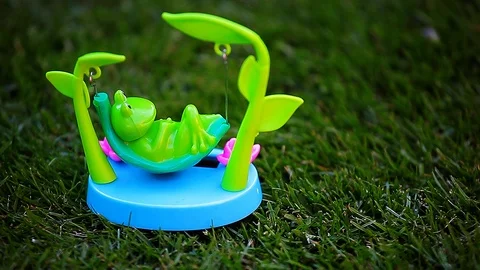 Plastic frog hammock grass background hd footage Stock Footage 109226013