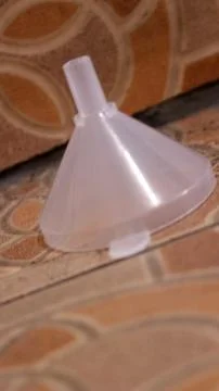 Plastic funnel isolated on ceramic Foto stock
