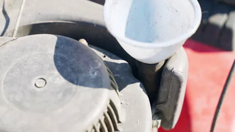 Plastic funnel for pouring engine oil in motor tank of lawn mower, preparation Stock Footage 273363013