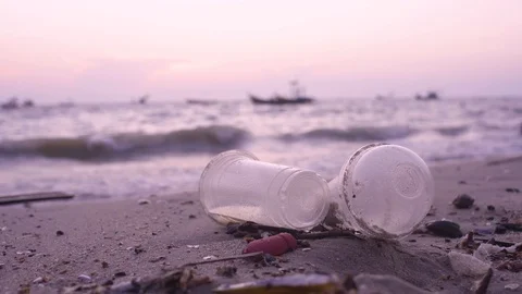 Plastic garbage and dirty waste on beach, Background sea and fishing boat Stock Footage 128672446