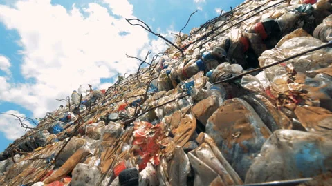 Plastic garbage compressed into cubical stacks in the open air Video stock 93784587