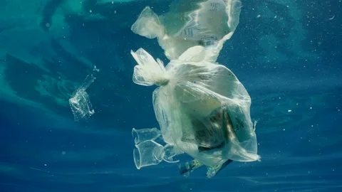 Plastic garbage drifts under surface of sea, slow motion Stock Footage 234793221