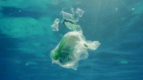 Plastic garbage drifts under surface of sea, slow motion Stock Footage 236686774
