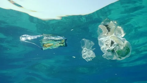 Plastic garbage drifts under surface of sea, slow motion. Plastic bags and other Stock Footage 241214890