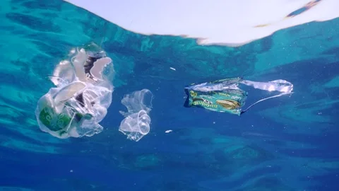 Plastic garbage drifts under surface of sea, slow motion. Plastic bags and other Stock Footage 253638985