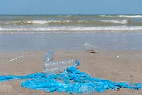 Plastic garbage dropped on the beach as poor environment and pollution problem. Stock Photos