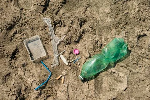 Plastic garbage left on a sandy beach. Stock Photos