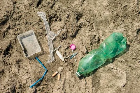 Plastic garbage left on a sandy beach. Stock Photos