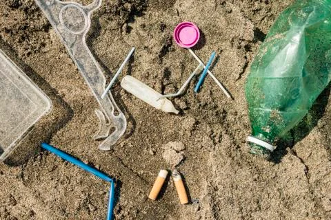 Plastic garbage left on a sandy beach. Stock Photos