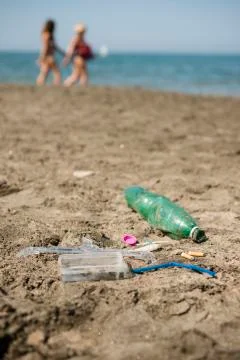 Plastic garbage left on a sandy beach. Stock Photos