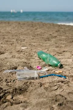 Plastic garbage left on a sandy beach. Stock Photos