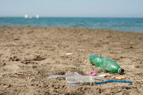 Plastic garbage left on a sandy beach. Stock Photos