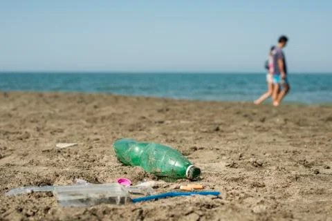 Plastic garbage left on a sandy beach. Stock Photos